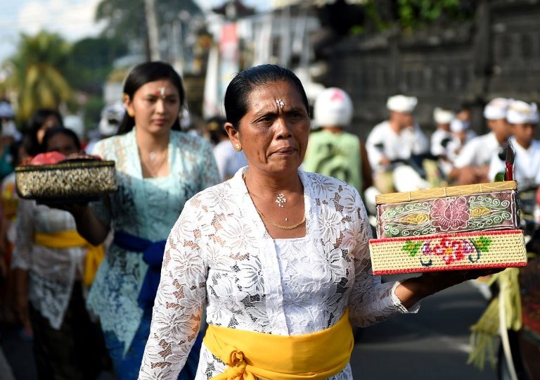 Balinese gather for prayers at a temple to celebrate Galungan day in Jimbaran, on Indonesia’s resort island of Bali, on April 5, 2017. 
Galungan is a holiday celebrated by Balinese as a sign of victory of good against evil. Photo: Sonny Tumbelaka/AFP