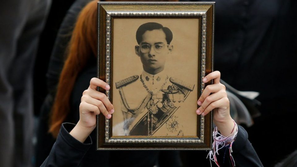 A woman holds a portrait of King Bhumibol Adulyadej. Photo: Reuters 
