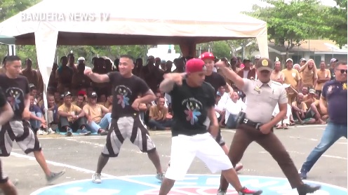 Prison guard dances with inmates of a Palawan penitentiary. Screengrab from Radyo Bandera 