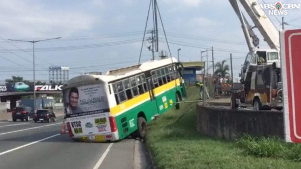 After falling off the elevated ramp at NLEX, the bus was towed out of the road. PHOTO: Screengrab from ABS-CBN footage
