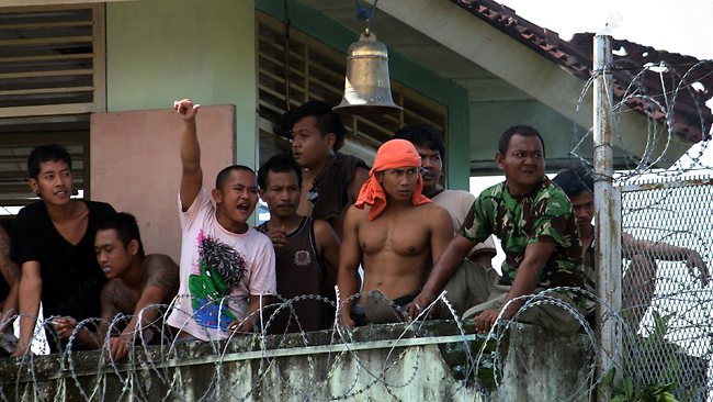 Prisoners look from a tower during the riot at Kerobokan prison in Bali. Photo: AFP (2012)