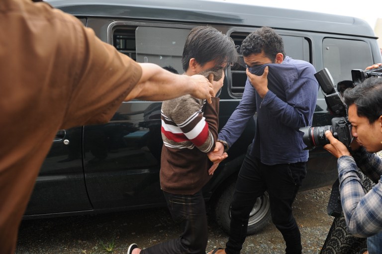 Two Indonesian men arrive for their trials at a shariah court in Banda Aceh on May 17, 2017. 
A sharia court on May 17 sentenced two men to be publicly caned for gay sex for the first time in Indonesia’s conservative province of Aceh, the latest sign of a backlash against homosexuals in the Muslim-majority country. PHOTO: AFP / CHAIDEER MAHYUDDIN