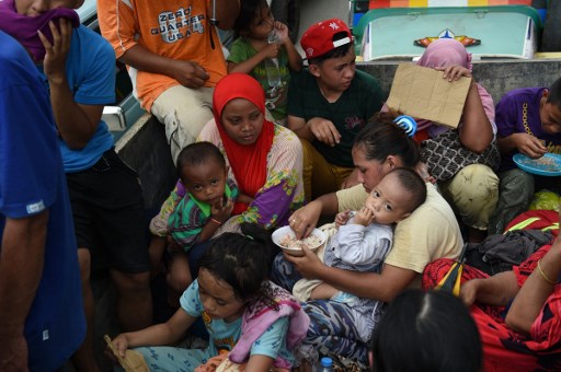 Resident fleeing from Marawi city,AFP PHOTO / TED ALJIBE